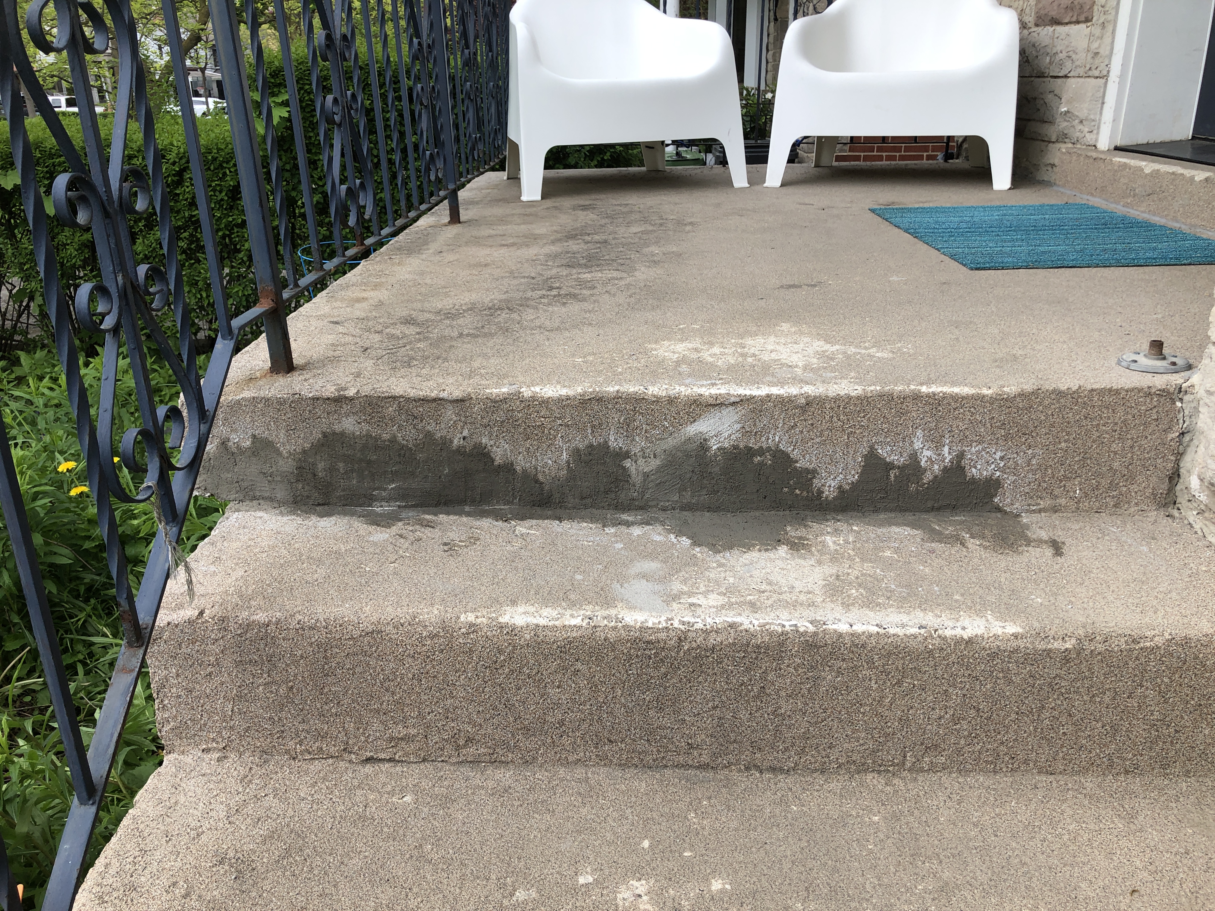 Concrete steps that have been patched. The cement is still wet.